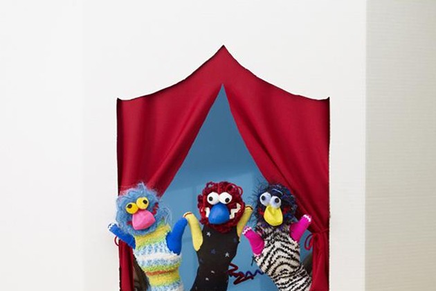 A puppet stage and hand puppets made from socks and old gloves.