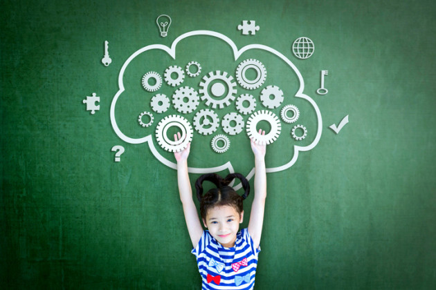 Little girl standing next to a green wall with imaginary gears above her head.